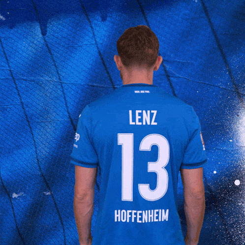 a man with his arms crossed wears a blue shirt with the word sap on it