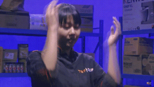 a woman wearing a top chef shirt is dancing in a warehouse