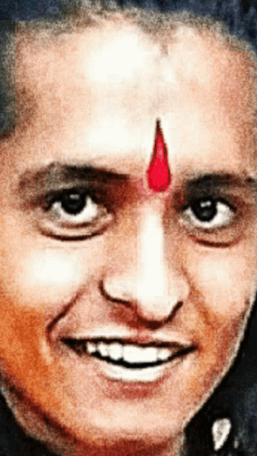 a close up of a man 's face with a red circle on his forehead