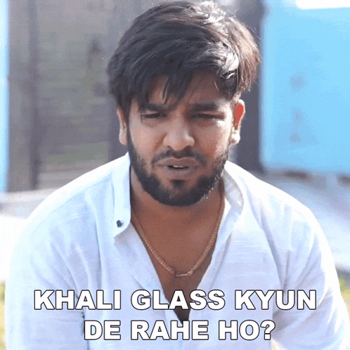 a man with a beard and a white shirt says khali glass kyun de rahe ho