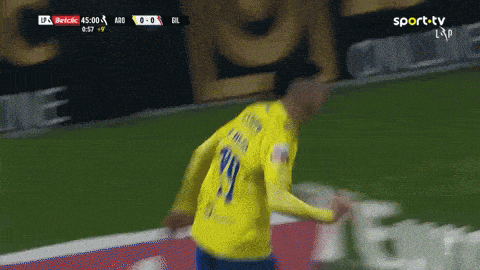 a soccer player in a yellow jersey with the number 19 on it
