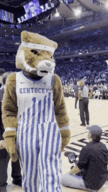 kentucky mascot wearing overalls and a headband