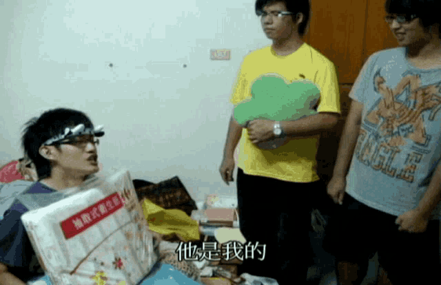 a man wearing a yellow shirt that says fragile is standing next to another man