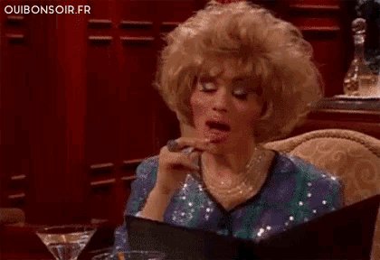 a woman in a wig is reading a menu in a restaurant