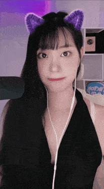 a girl wearing purple cat ears and ear buds