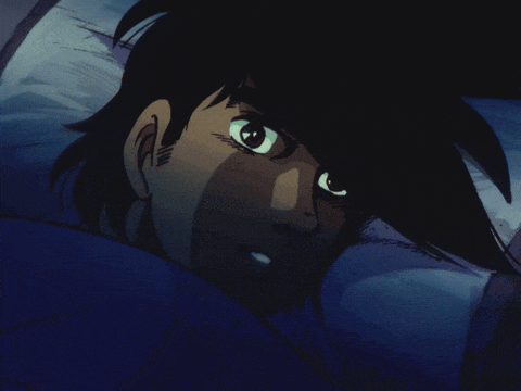 a close up of a person laying in bed with their eyes closed