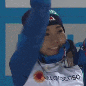 a woman wearing a blue hat and a white shirt that says clorogeno on it