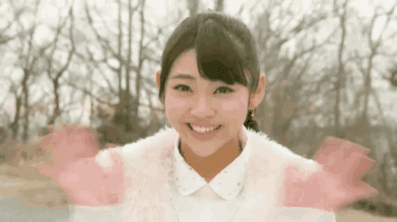 a young woman in a white fur coat smiles for the camera