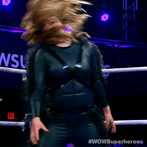a woman is in a wrestling ring with the words wowsuperheroes on the bottom