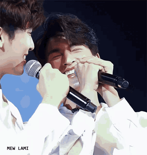 two men singing into microphones with the name mew lami written on the bottom