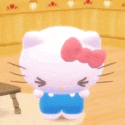 hello kitty is wearing blue overalls and a pink bow and is standing on a wooden floor .