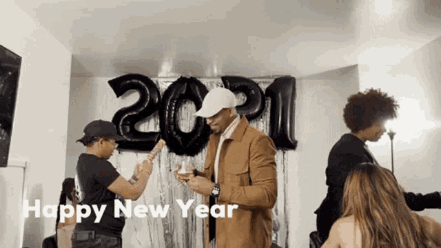 a group of people are celebrating a new year 's eve party with balloons in the shape of the number 2021