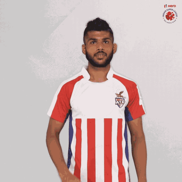 a man wearing a red white and blue striped jersey with the word hero on the bottom
