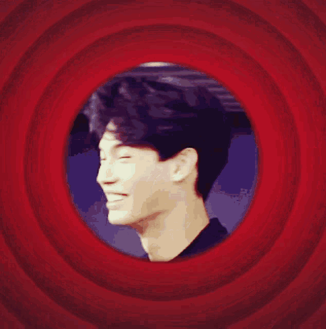 a man is laughing in a red circle with white lines