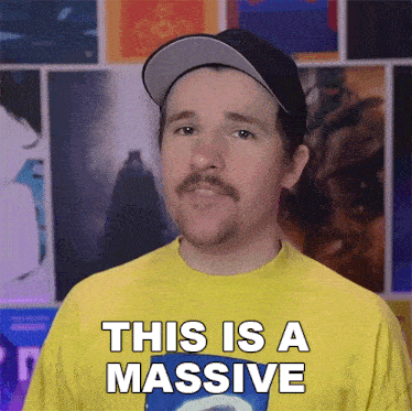 a man with a mustache wearing a yellow shirt says this is a massive