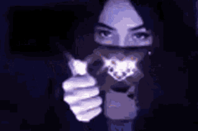 a pixelated image of a woman holding a light bulb in her hand