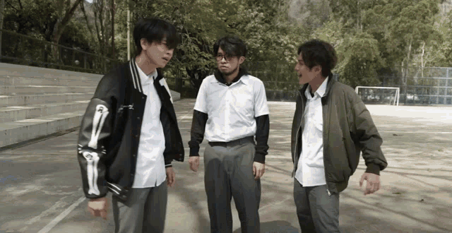 a man with a skeleton arm is talking to two other people