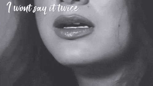 a black and white photo of a woman 's face with the words " i won t say it twice " above her