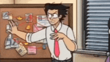 a man in a tie is standing in front of a bulletin board with a lot of papers on it .