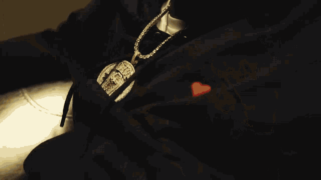 a man in a black hoodie sits in a chair
