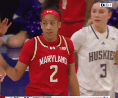 a female basketball player wearing a red jersey with the number 2