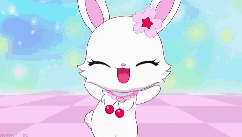 a white rabbit with pink ears and red eyes is wearing a pink necklace with cherries on it 's neck .