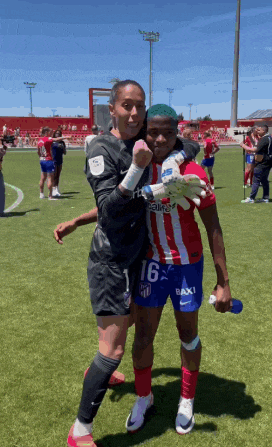 two female soccer players are posing for a picture with one wearing a number 16 jersey