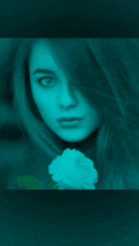 a close up of a woman 's face with a flower in the background