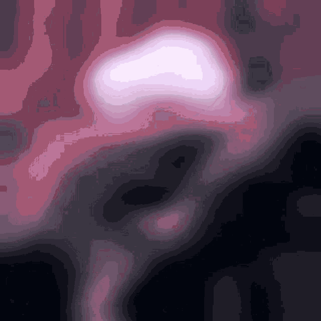 a blurred image of a person 's face with a pink glow in the middle
