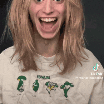 a woman is wearing a t-shirt with vegetables on it