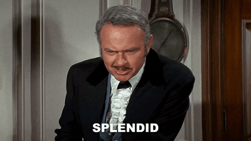 a man in a suit and tie with the word splendid behind him