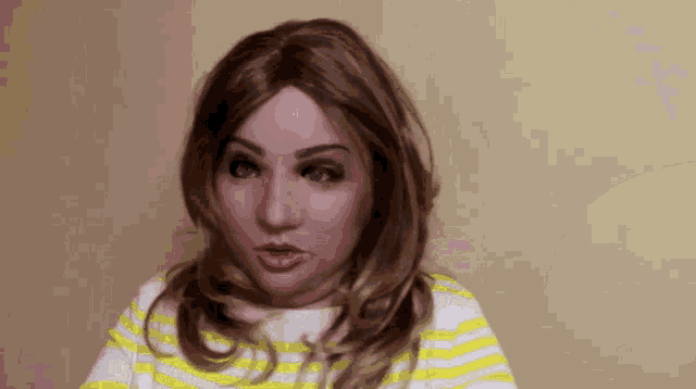 a woman with a mask on her face is wearing a striped shirt