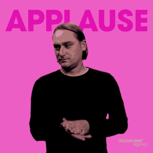a man is applauding in front of a pink background that says " applause "