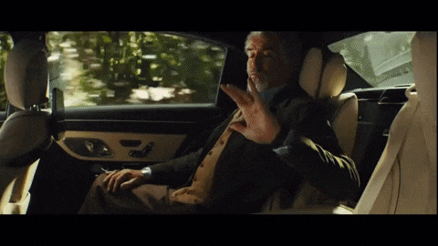 a man sitting in the back seat of a car