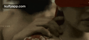 a woman is kissing another woman 's neck in a close up .