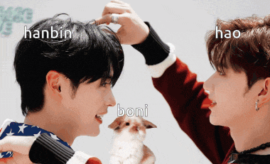 hanbin and hao are standing next to each other holding a bunny