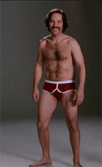 a shirtless man with a mustache and red underwear