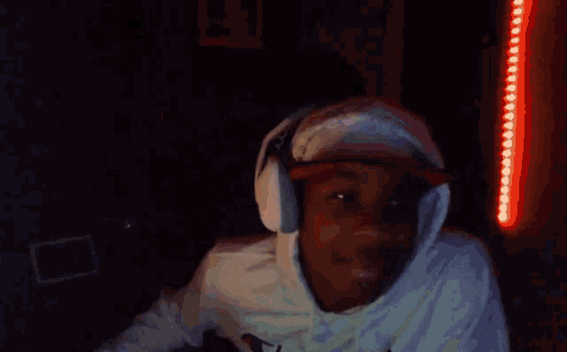 a blurry picture of a man wearing headphones in a dark room