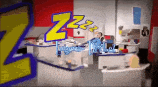 a cartoon of a man sleeping in an office with the word zzz coming out of his head