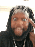 a man with dreadlocks making a funny face