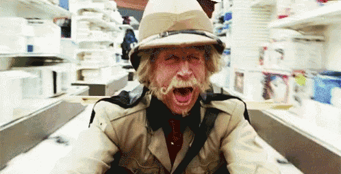 a man with a hat and a mustache screams in a store