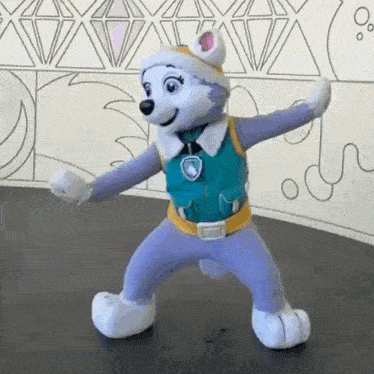 a stuffed animal from paw patrol is dancing on a table .
