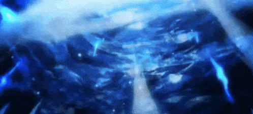 a close up of a blue water surface with bubbles coming out of it