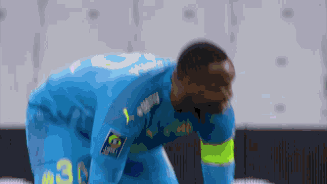 a soccer player in a blue uniform with the number 30 on it