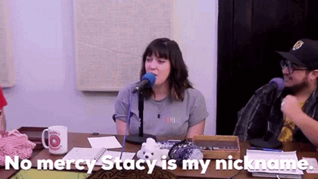 a woman singing into a microphone with the words " no mercy stacy is my nickname " next to her