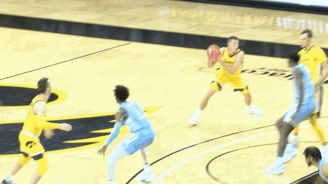 a basketball game is being played on a court with the letters iowa on the side