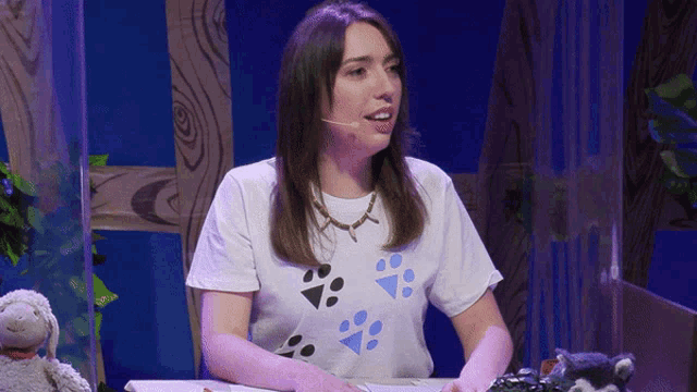 a woman in a white shirt with paw prints on it
