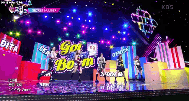a group of girls performing on a stage with the words got boom written on it