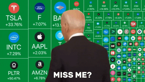 a man in a suit stands in front of a display of stocks with the words miss me below him