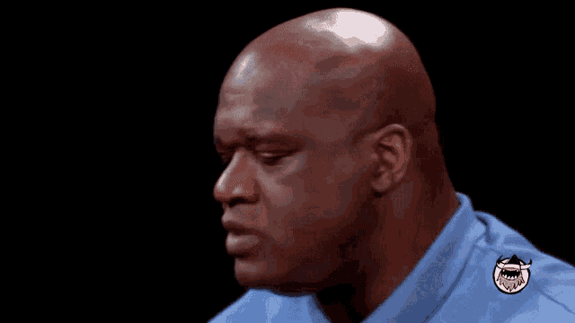 a bald man in a blue shirt with the words nbanicks is typing